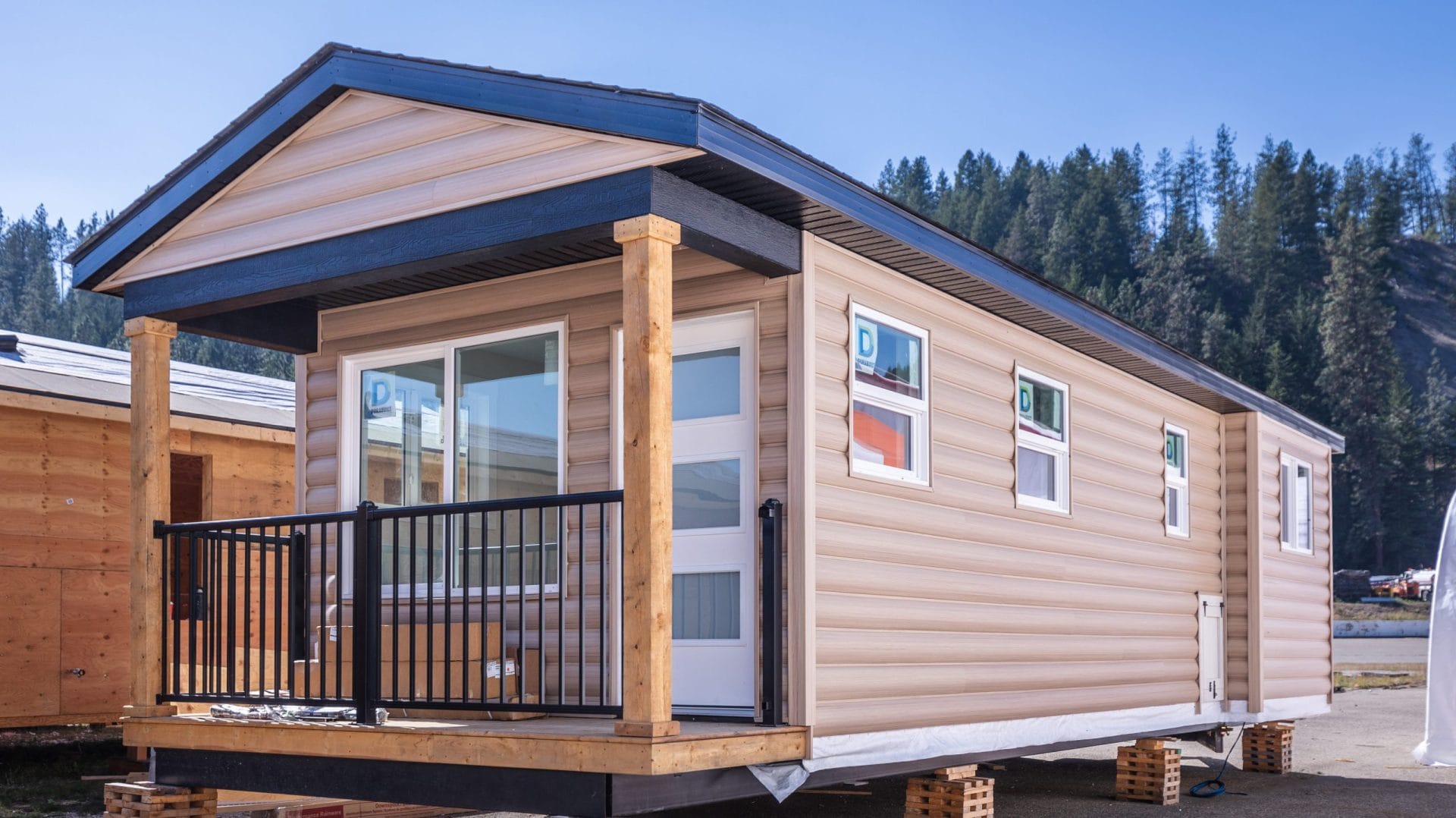 Completed modular home exterior in British Columbia with covered entry and modern siding
