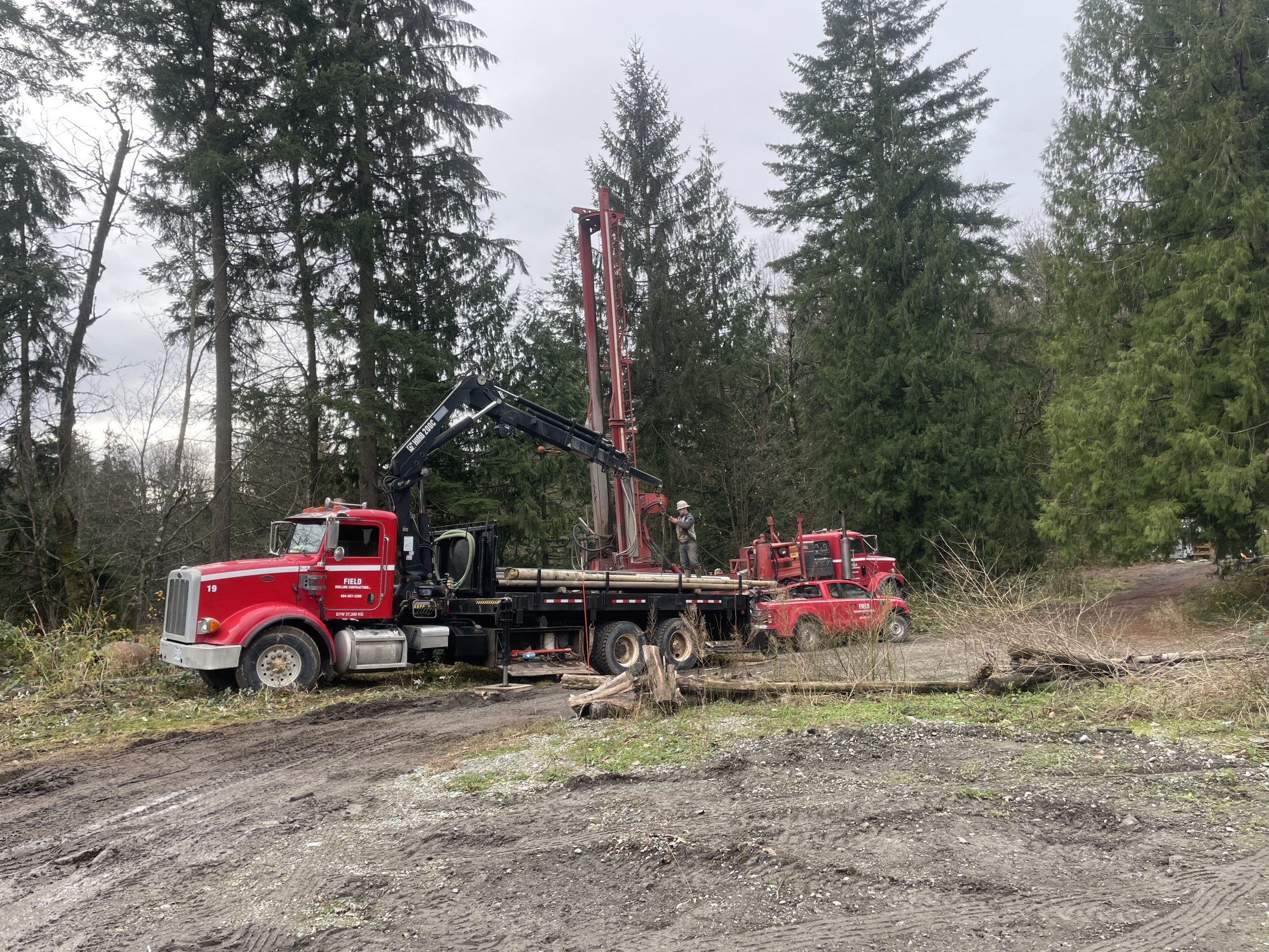 Modular home site development in British Columbia showing foundation, excavation, and exterior setup work in progress