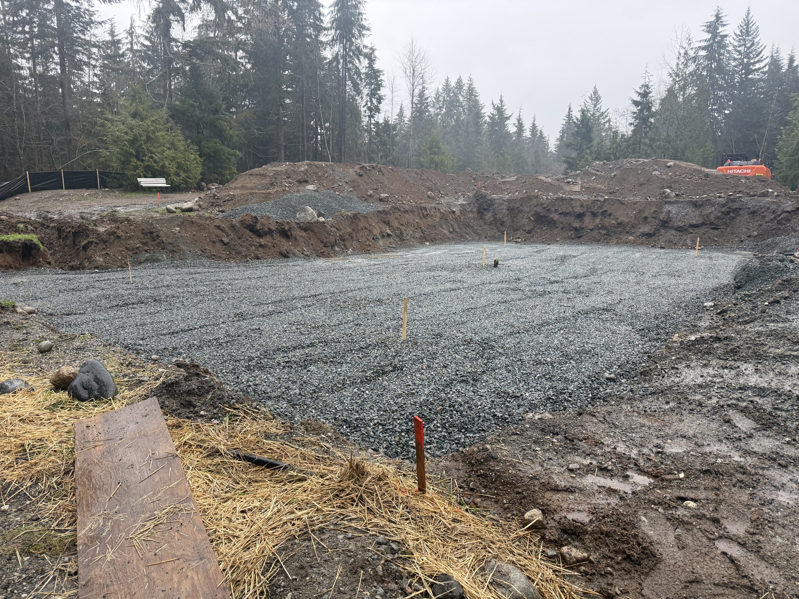 Modular home gravel pad foundation in British Columbia prepared for home installation with leveled base and site work completed